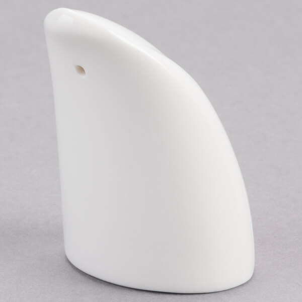 A white porcelain pepper shaker with a small hole.