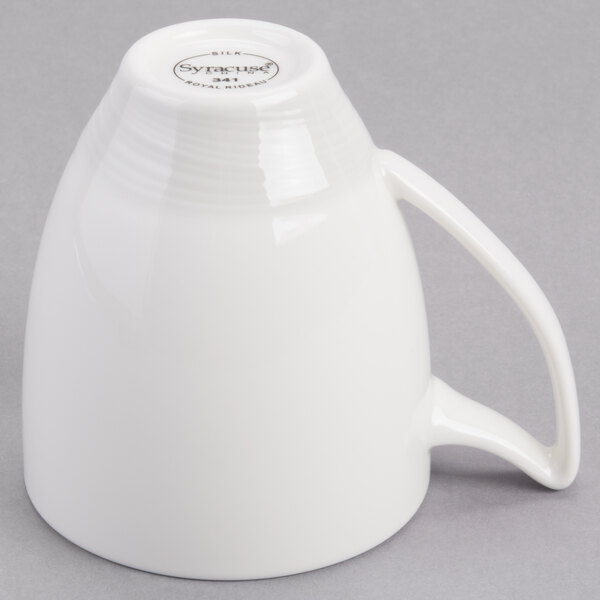 A white Royal Rideau porcelain mug with a handle.