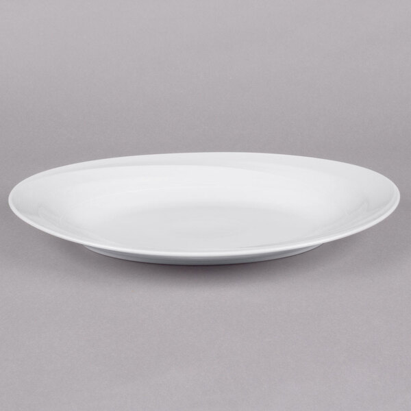 A white narrow rim oval porcelain platter on a white background.
