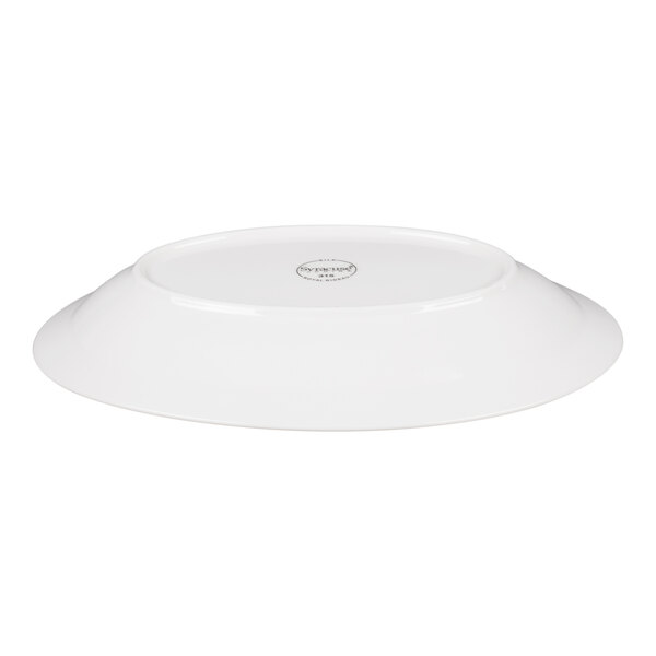 A white oval porcelain platter shown upside down with a visible maker's mark on the bottom.