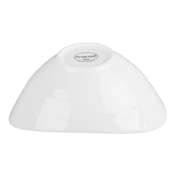 A white, oval-shaped porcelain bowl shown upside down with a small circular base and a printed mark on the bottom.