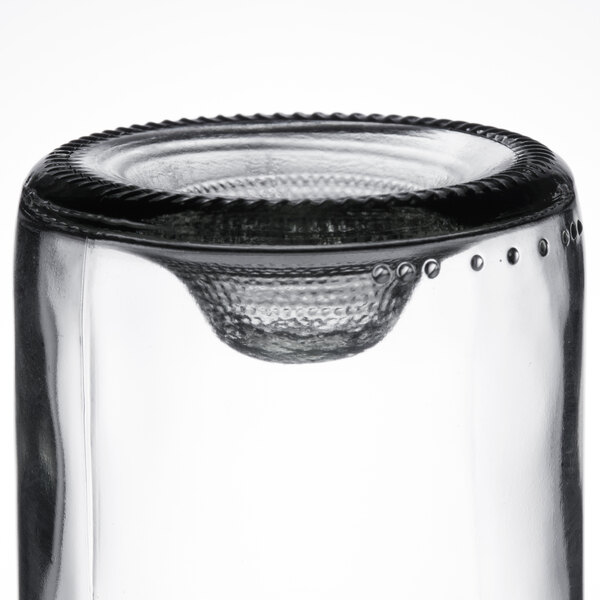 A close up of a clear Arcoroc wine tumbler on a table.