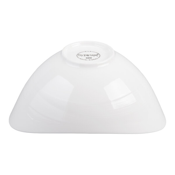 A white porcelain bowl shown upside down on a plain background.