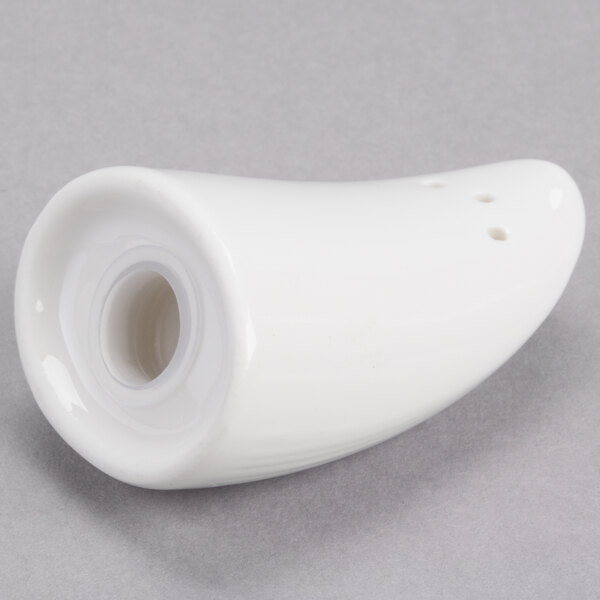 A white porcelain salt shaker with a hole in it.