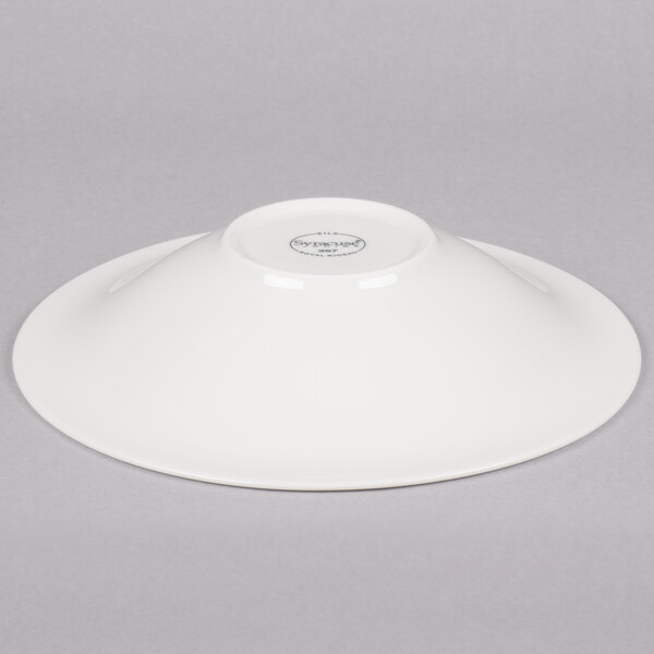 A white Reserve by Libbey round porcelain coupe bowl on a gray background.