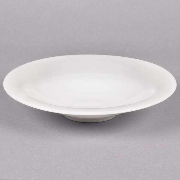 A white Reserve by Libbey Royal Rideau coupe bowl on a gray surface.