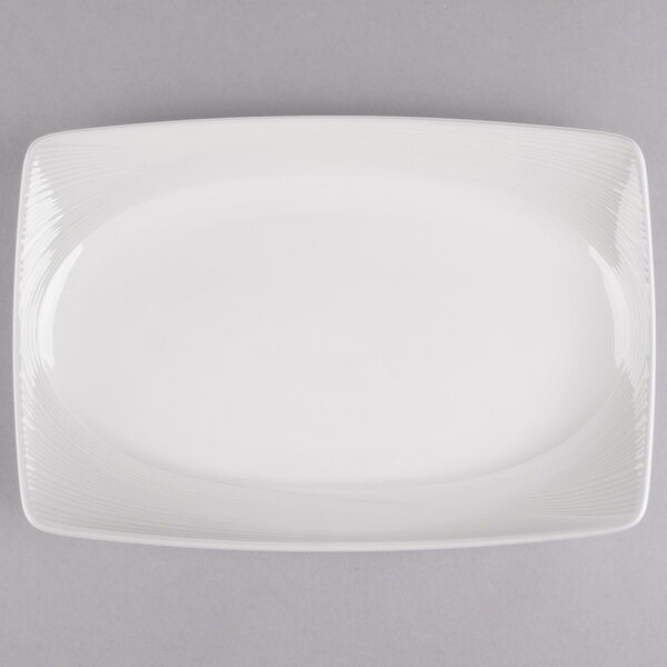 A white rectangular porcelain platter with a thin curved edge.
