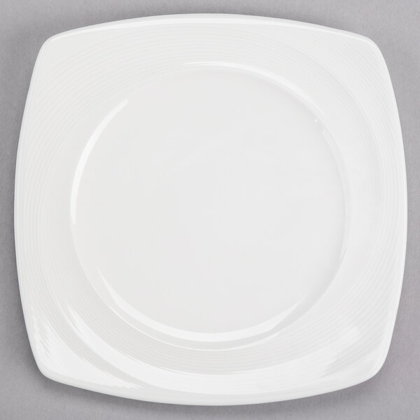 A white Reserve by Libbey porcelain plate with a thin wide rim.