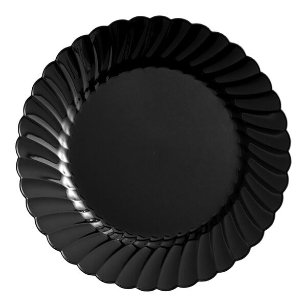 A black plastic plate with scalloped edges.