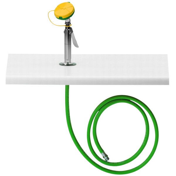 A green hose with a metal connector attached to a white surface.