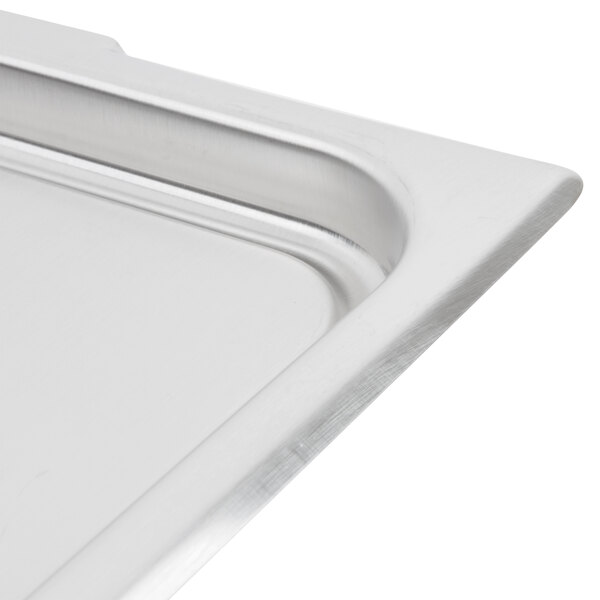 A Vollrath stainless steel cover on a metal tray.