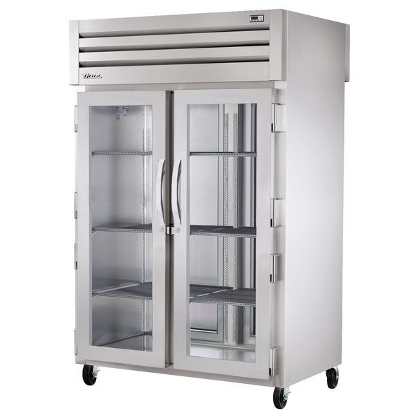 A True pass-through refrigerator with glass doors.
