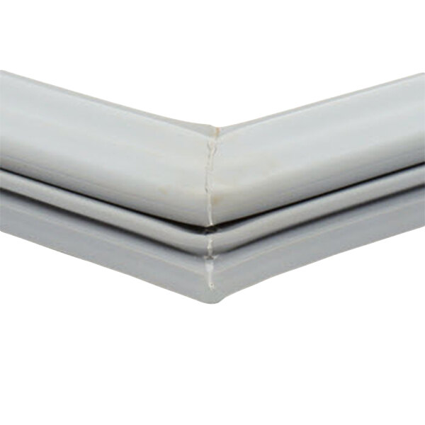 A white plastic corner of a Delfield magnetic door gasket.