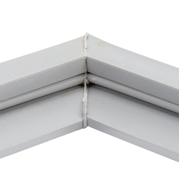 A close-up of a white corner piece of a Delfield 1702640 equivalent magnetic door gasket.