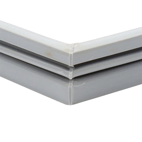 A close up of a gray plastic corner on a Delfield Equivalent Magnetic Door Gasket.