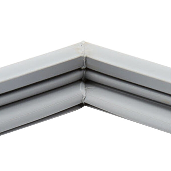 A close up of a gray corner bracket on a white frame.