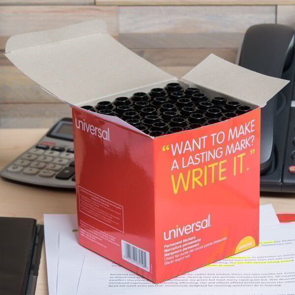 A box of Universal black chisel tip permanent markers on a desk.