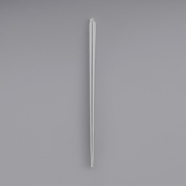 A clear plastic prism food pick.