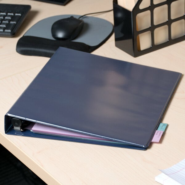 An Avery navy blue heavy-duty view binder on a desk.