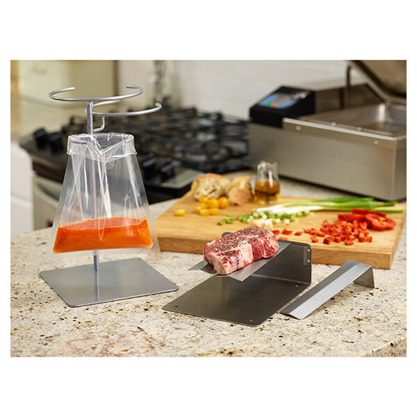 A piece of meat on a cutting board being placed in a plastic bag on a stainless steel rack.