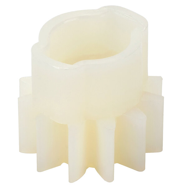 A close-up of a white plastic gear with a small hole in the center.