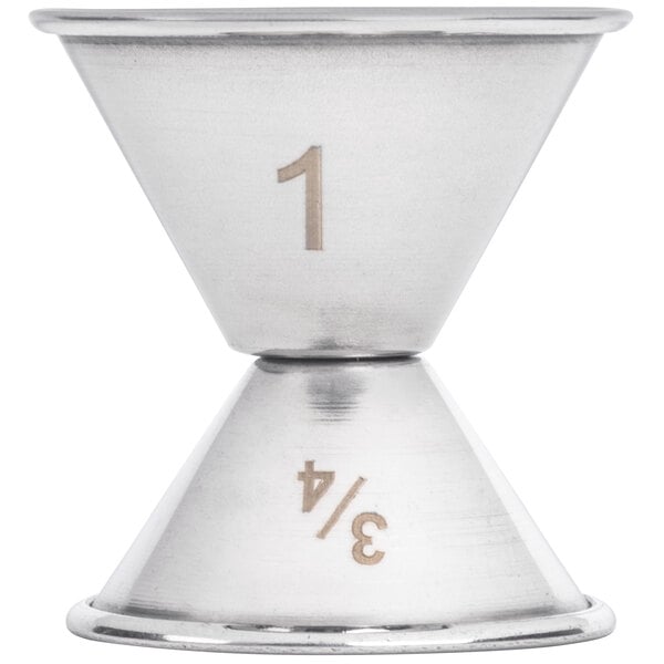 An American Metalcraft stainless steel jigger with 0.75 oz. and 1 oz. measurements on a white surface.