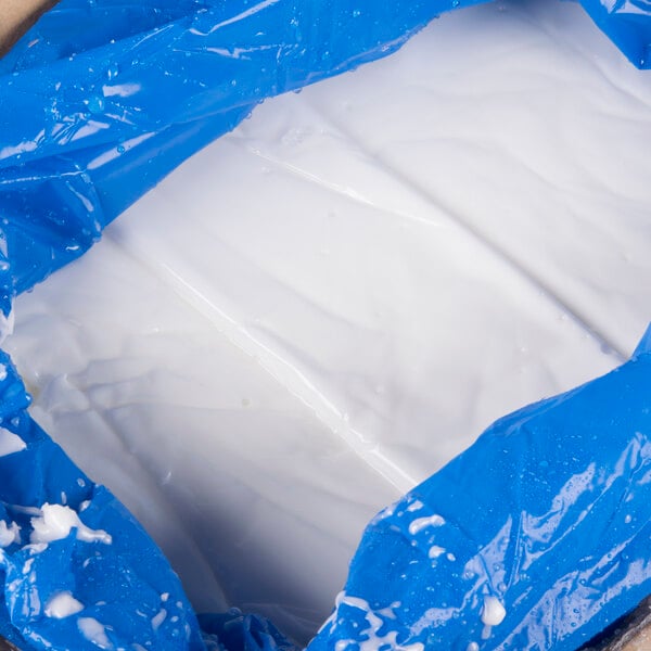 A plastic container filled with white Golden Barrel Creme Fondant powder.