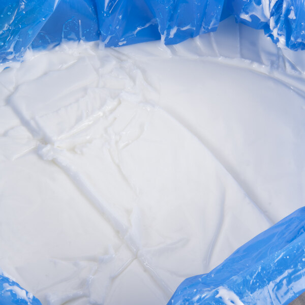 A close-up of a white liquid in a blue plastic bag.