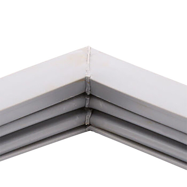 A close up of a white metal corner of a Traulsen refrigerator door gasket.