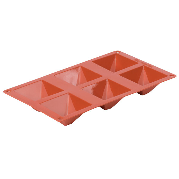 A red silicone baking tray with six pyramid-shaped compartments.