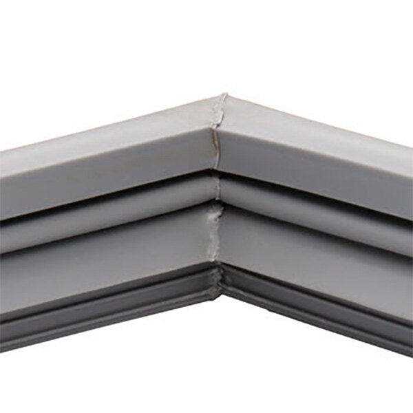 A close up of a gray corner piece of a Traulsen magnetic door gasket.