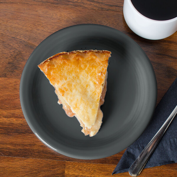 A piece of pie on a Fiesta® Slate China Appetizer Plate next to a mug of coffee.