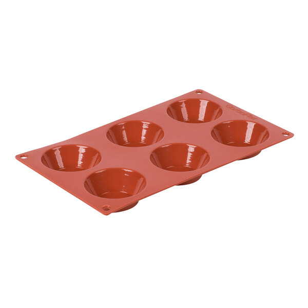 A red silicone baking pan with six Tatin molds.