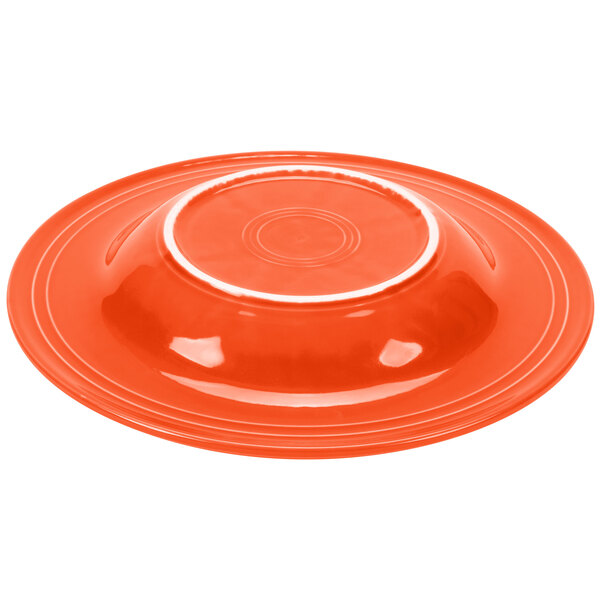 A red Fiesta pasta bowl with a white rim.