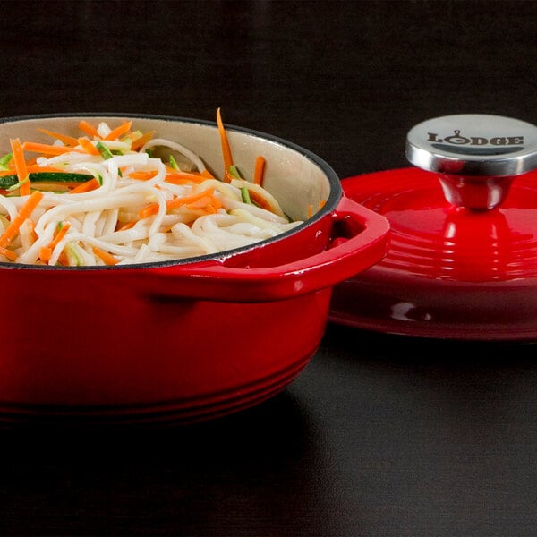 A red Lodge enameled cast iron dutch oven with food in it on a kitchen counter.