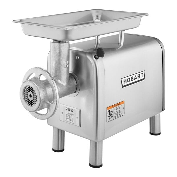 A silver metal Hobart meat chopper with a stainless steel tray.