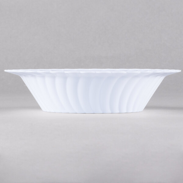 A close up of a white Fineline Flairware plastic bowl with a wavy design.