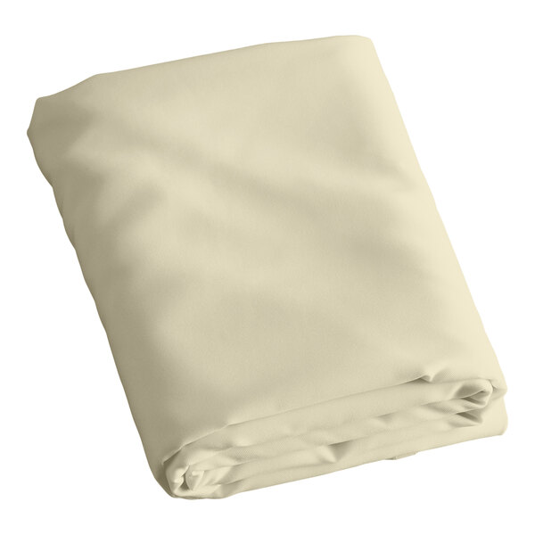 A folded ivory round table cover on a white background.