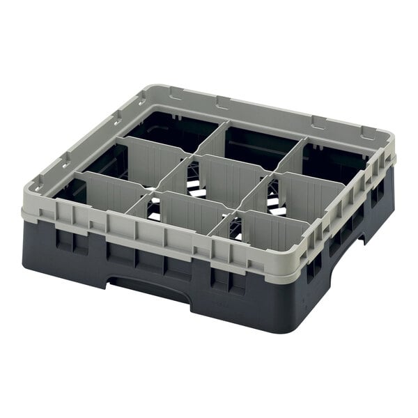 A black and grey plastic Cambro glass rack with six compartments.