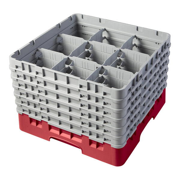 A red plastic Cambro glass rack with 9 compartments and 6 gray extenders.