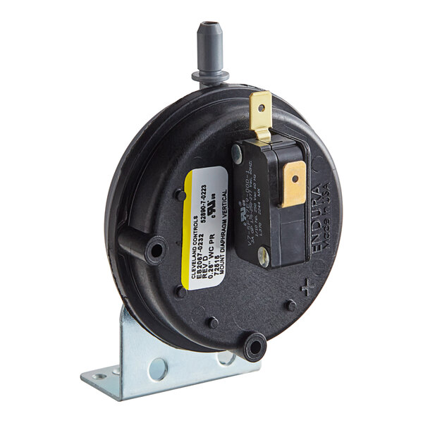 A black Henny Penny vacuum switch with a white label and yellow light.