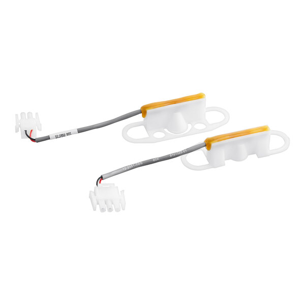 A white plastic package with a yellow label containing Ice-O-Matic Level Sensor Kit with two white plastic strips with wires.