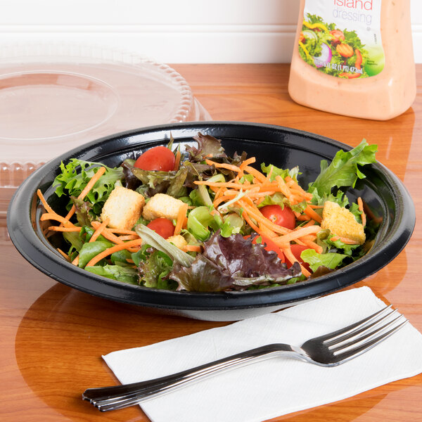 A salad in a black Genpak foam utility bowl.