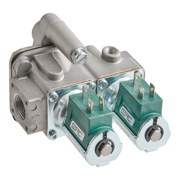 A metallic gas valve assembly with two green electrical solenoid components attached.