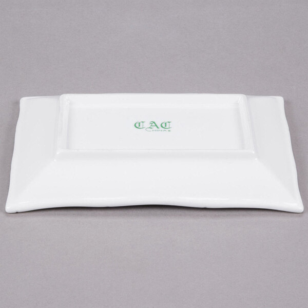A white rectangular porcelain platter with bamboo pattern in green.