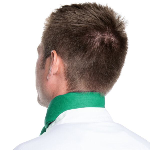 The back of a man wearing a green Intedge chef neckerchief with white polka dots.
