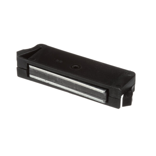A black rectangular object with a metal handle.