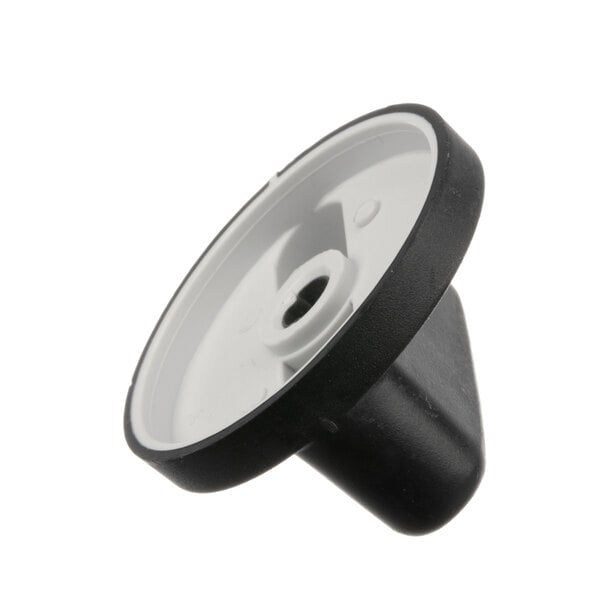 A close-up of a black and white Crown Steam knob with a hole in the center.