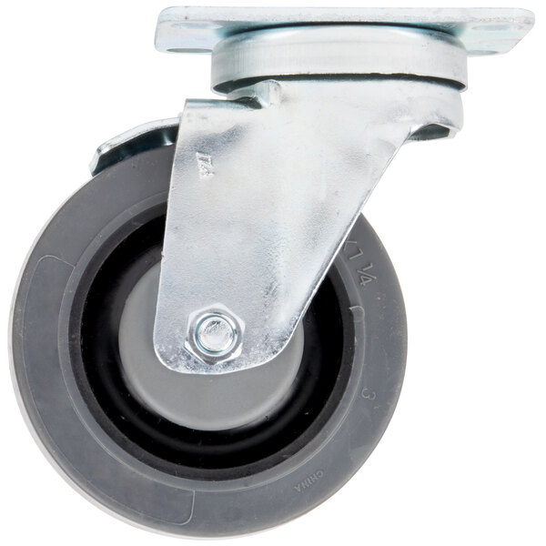 A close-up of a black metal wheel on a Garland and US Range swivel plate caster with brake.