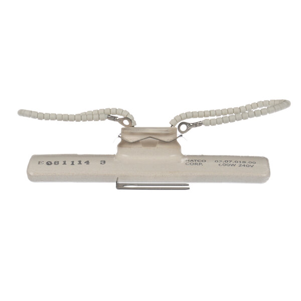 A white device with two wires attached to it.